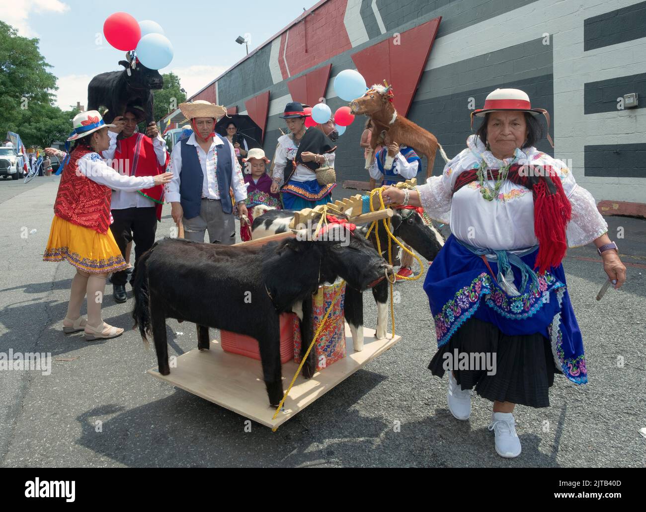 Marchers in traditional clothing and with wooden animal statues.at the Ecuadorian Parade NYC 2022 in Queens, New York. Stock Photo