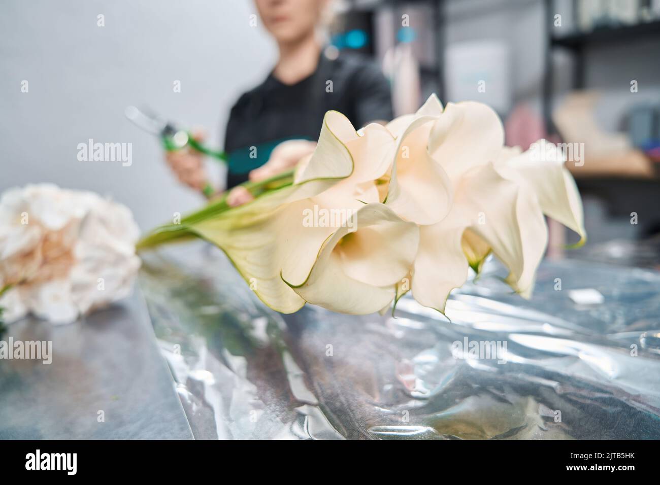 On counter in flower shop lies bouquet of calla lilies Stock Photo Alamy