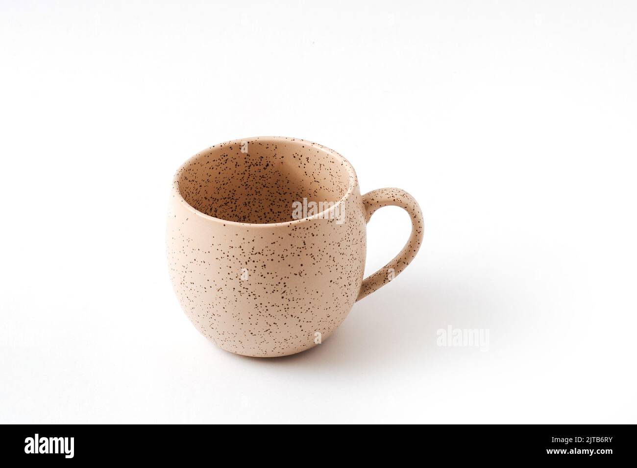 Empty beige coffee ceramic cup on isolated white background, cut out. View from above. Stock Photo