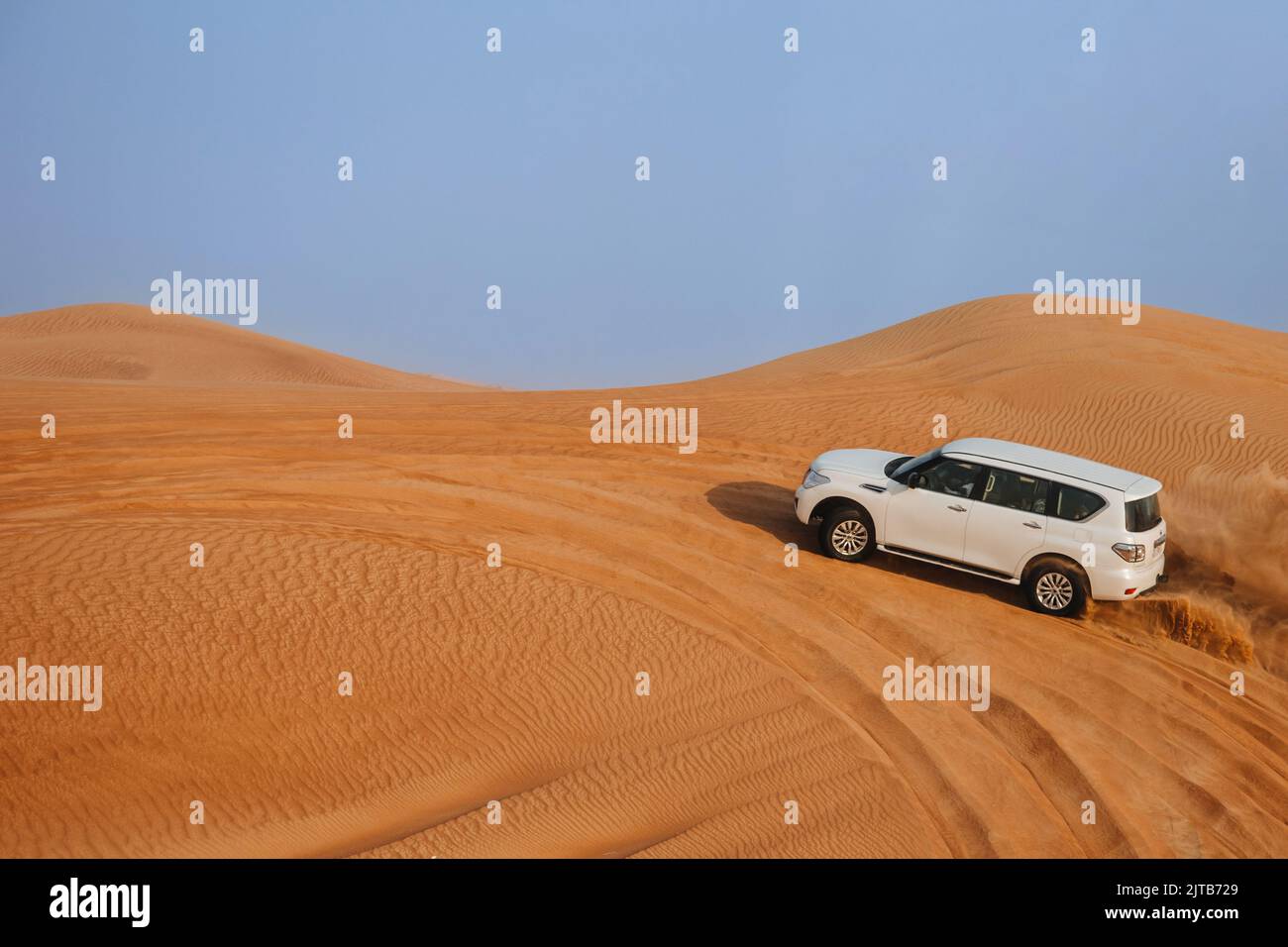 Dubai, United Arab Emirates - 01, July 2021 : The car ride at Arabian Desert over the dunes. A warm day in the desert. Stock Photo