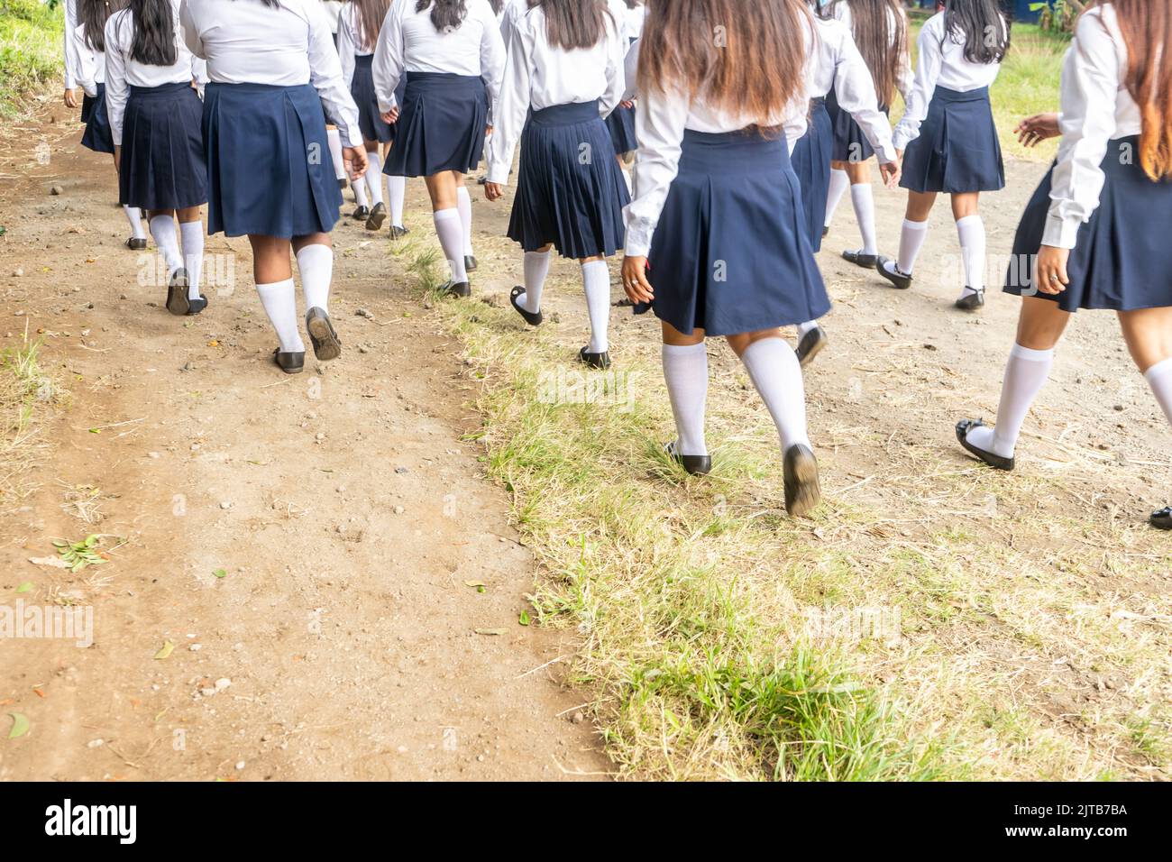 Group of high school student girls walking and wearing uniforms Stock Photo