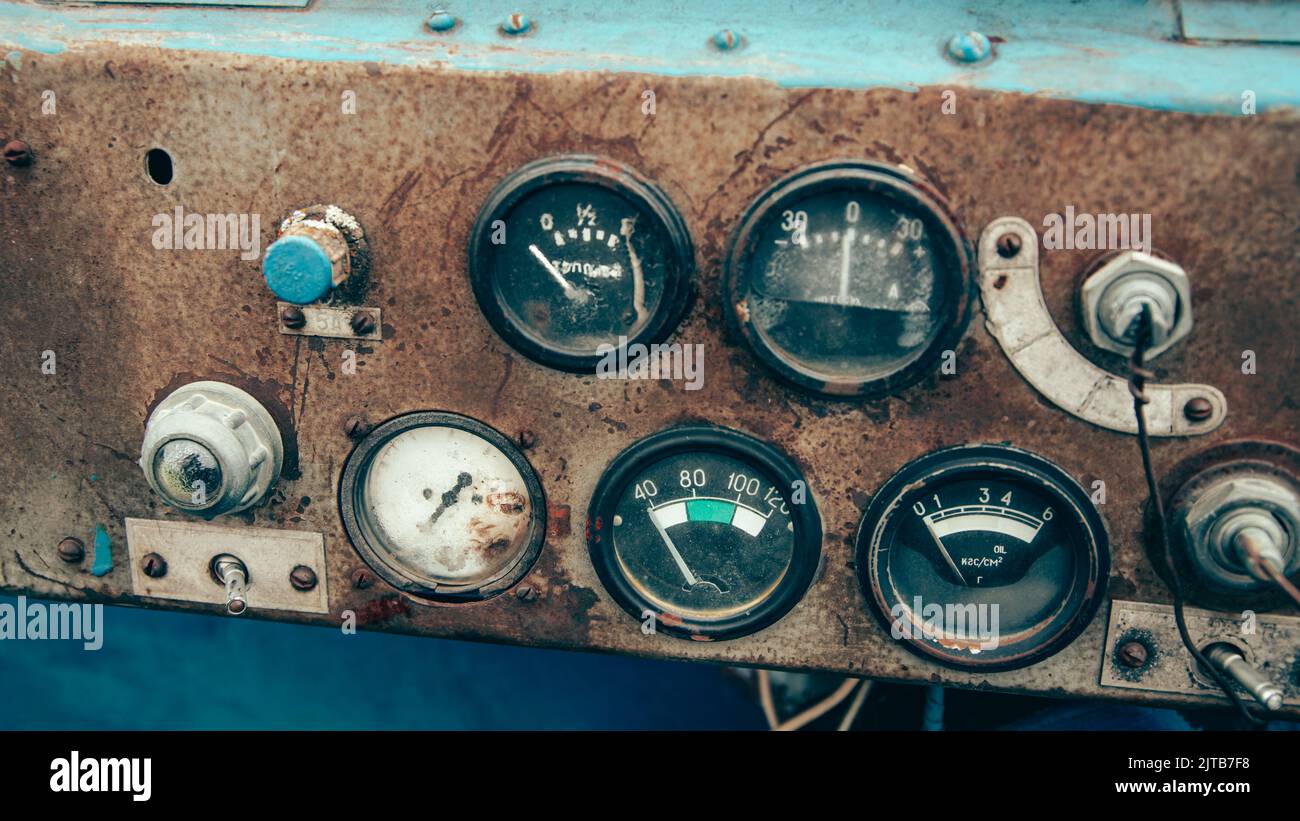 The rusty steel dashboard of a very old tractor close-up Stock Photo