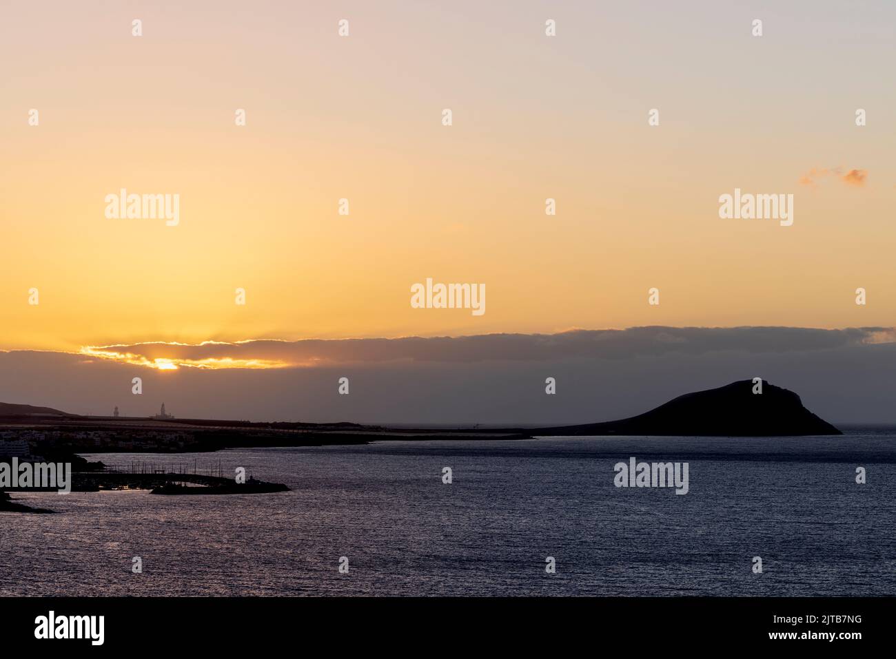 Red mountain, Montaña Roja in silhouette at sunrise. Dawn on the east coast of Tenerife, Canary Islands, Spain Stock Photo