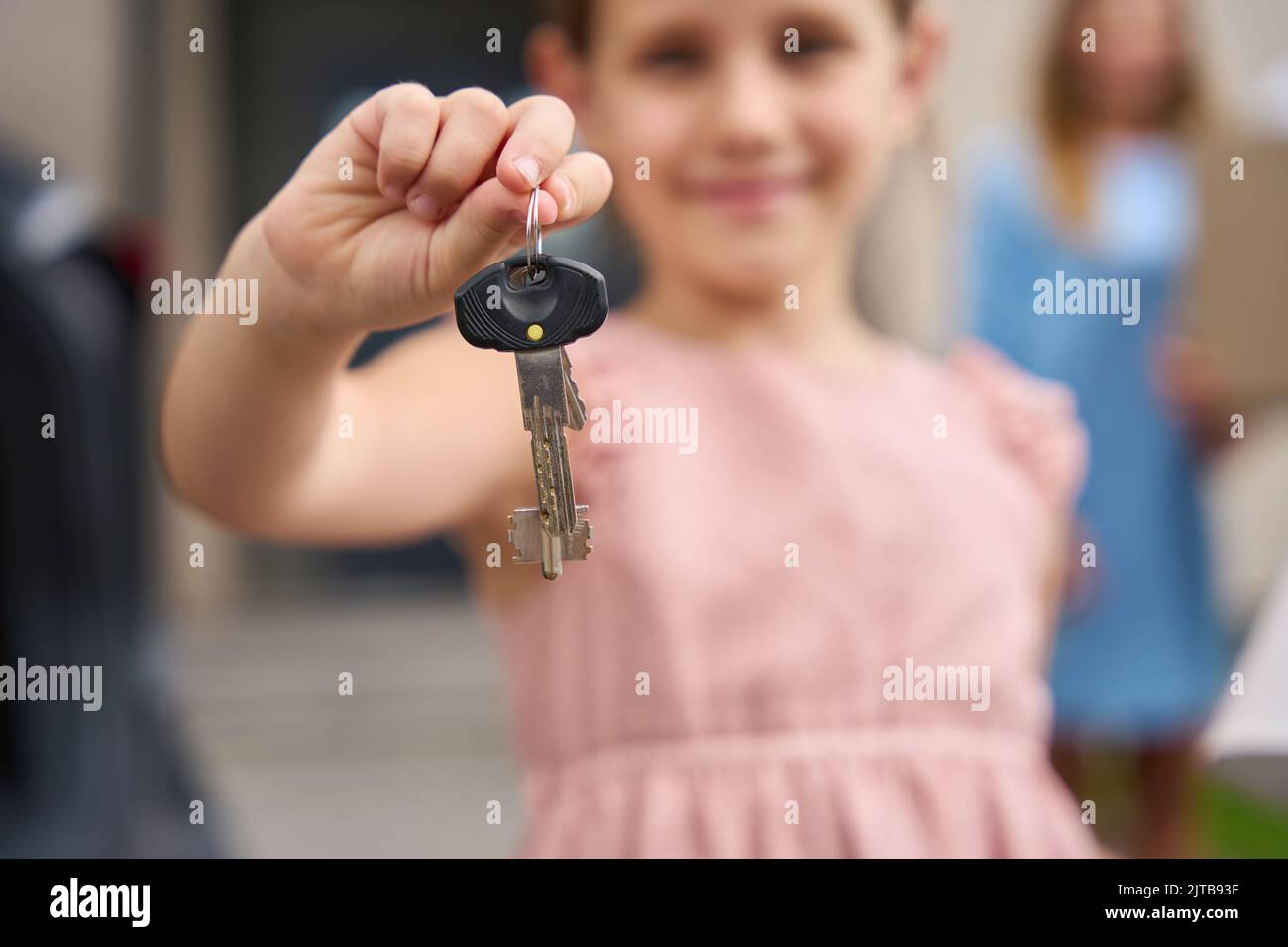 Portrait of pretty girl who shows keys to new house Stock Photo - Alamy
