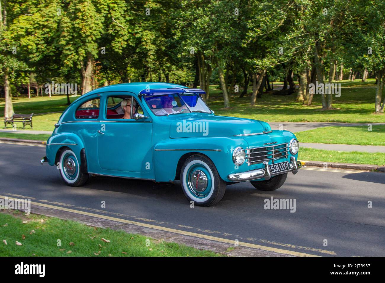 1954 50s fifties Blue VOLVO PV444-HB 1414cc petrol Swedish sedan; Cars arriving at the annual Stanley Park Classic Car Show in the park gardens. Stanley Park classics yesteryear Motor Show Hosted By Blackpool Vintage Vehicle Preservation Group, UK. Stock Photo