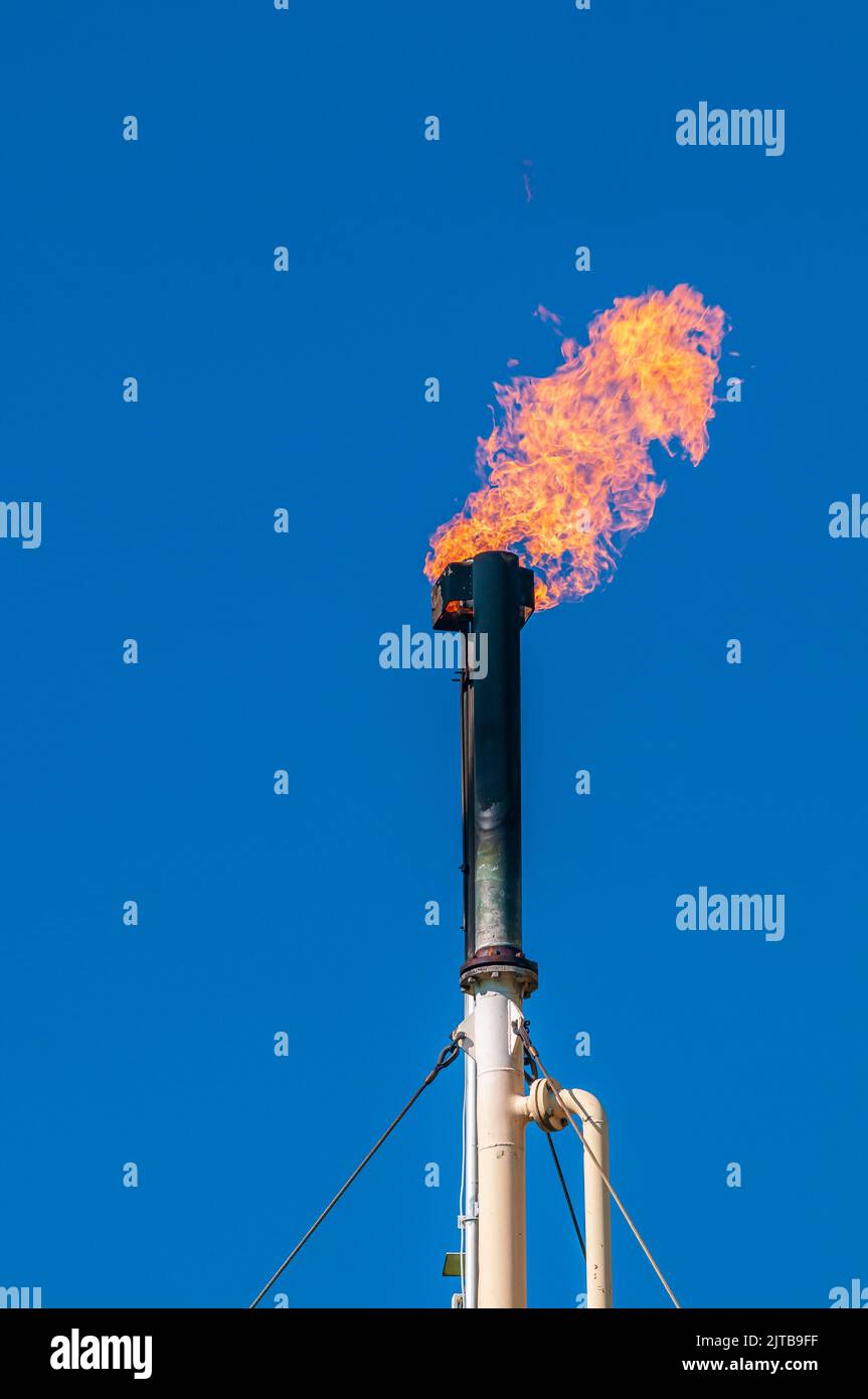 A flare stack on a sour gas well is blackened with soot Stock Photo Alamy