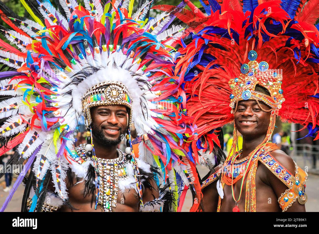 London, UK. 29th Aug, 2022. Two male samba dancers in feather head gear. Participants and revellers have fun along the main parade at Notting Hill Carnival 2022. The carnival, a celebration of Caribbean culture, returns to London after 2 years of restrictions and is expected to easily exceed 1 million visitors again this year. Credit: Imageplotter/Alamy Live News Stock Photo
