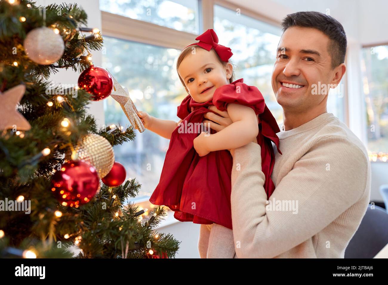 happy father and baby girl decorate christmas tree Stock Photo - Alamy