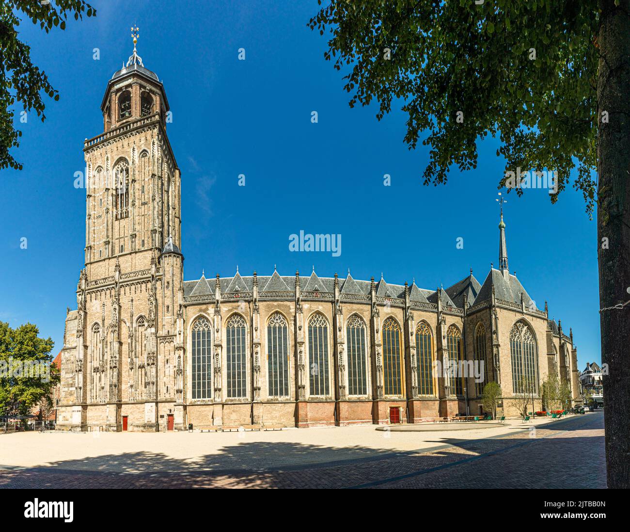 St Lebuïnus Church in Deventer, Netherlands. Lebuïnus church in Deventer with the 2022 redesigned forecourt. In the past, cars used to park around the church, but today the square once again belongs to the residents of the city with a water feature, benches and a children's playground Stock Photo