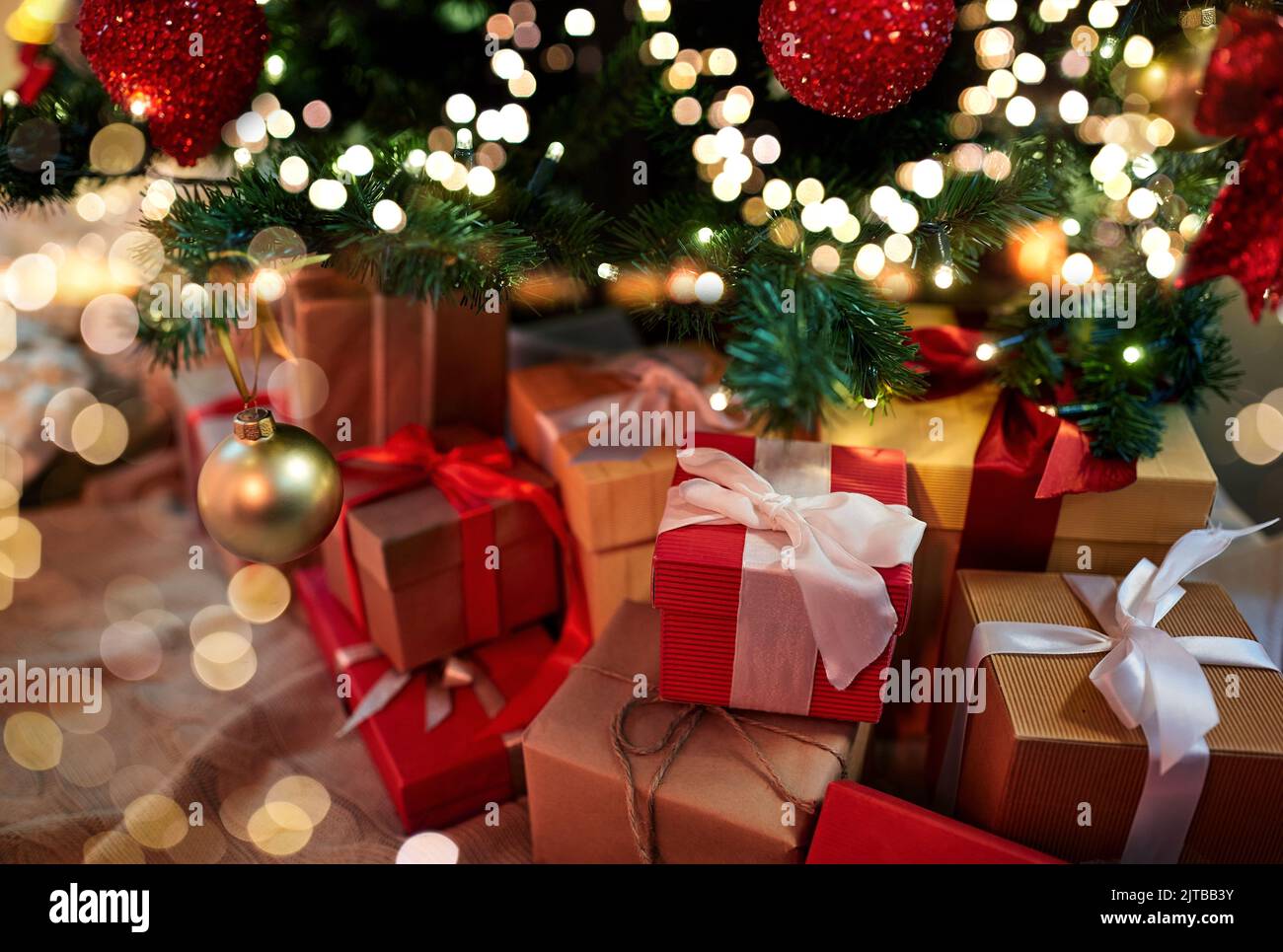 gift boxes under decorated christmas tree at home Stock Photo - Alamy