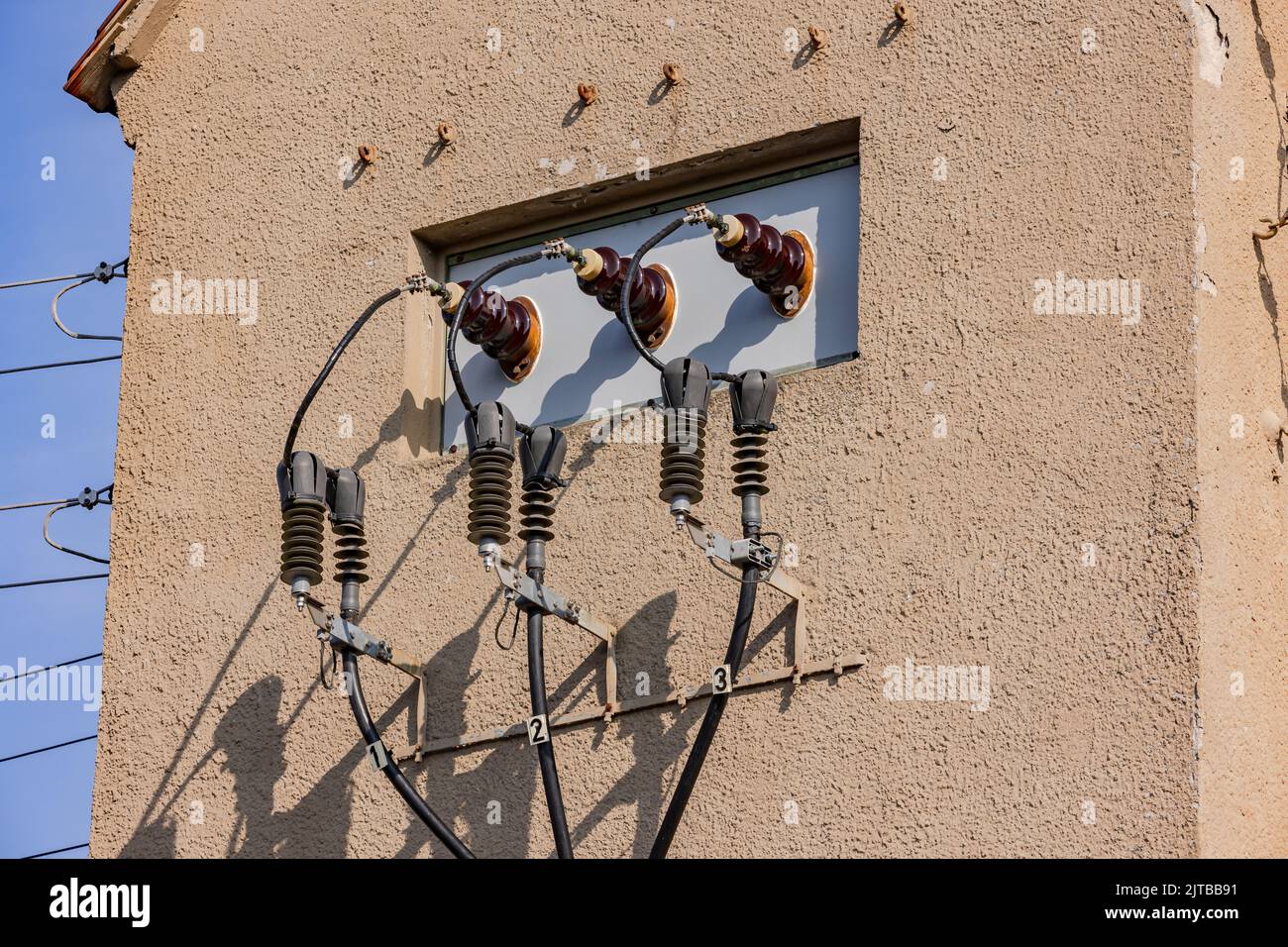 Power lines and resistances of a tower for transformation of electricity, Germany Stock Photo