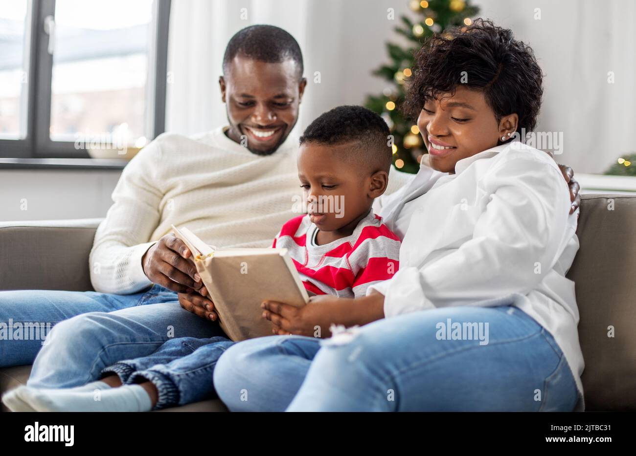 african-family-reading-book-on-christmas-at-home-stock-photo-alamy