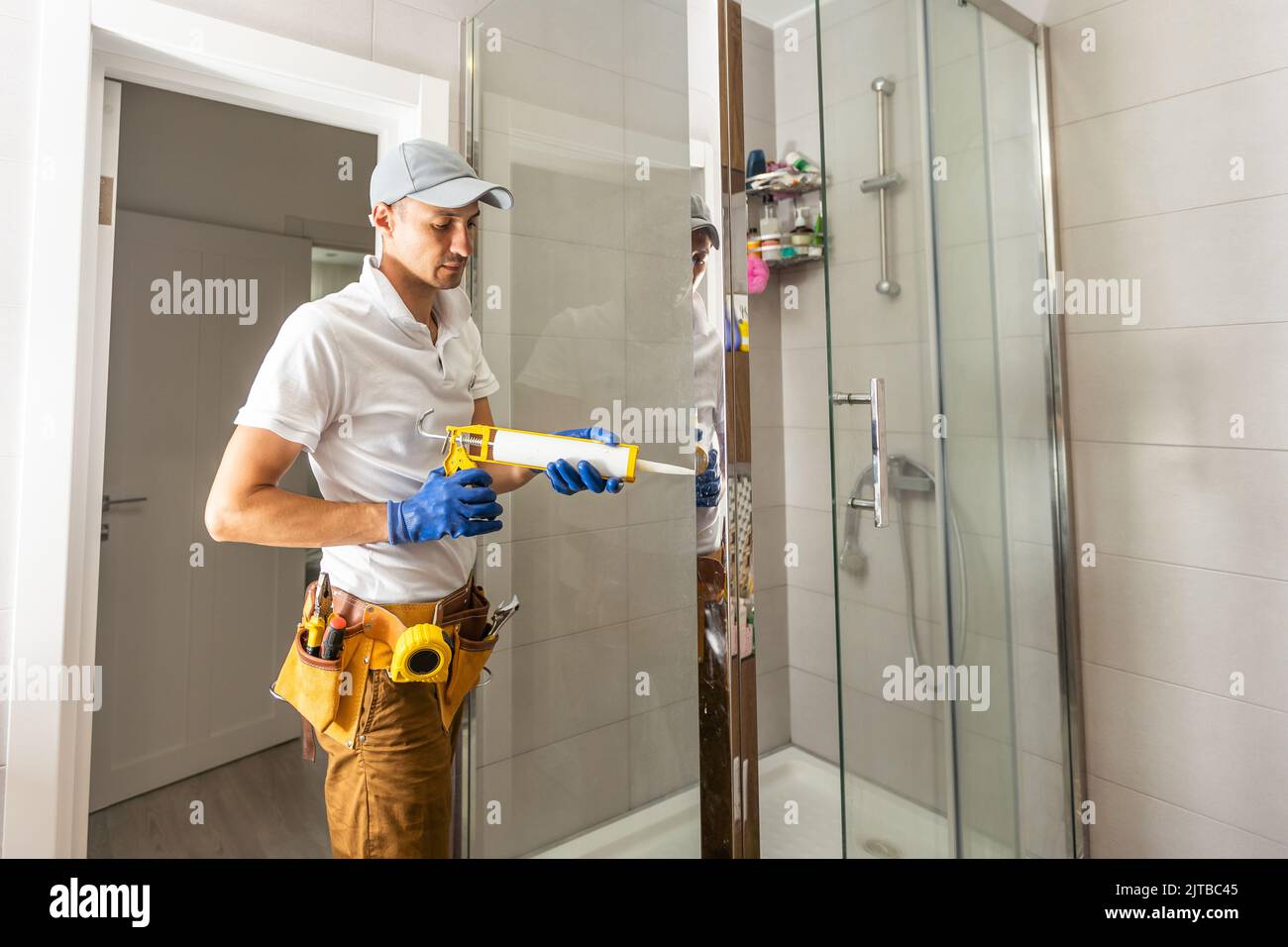 Plumber installing shower stall, work in bathroom Stock Photo Alamy
