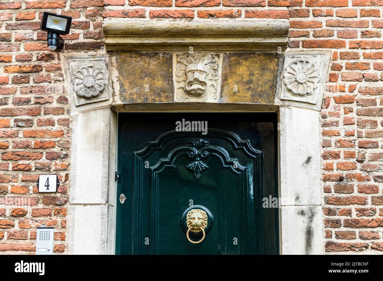 Grim faces should keep evil away from the house in Deventer, Netherlands Stock Photo