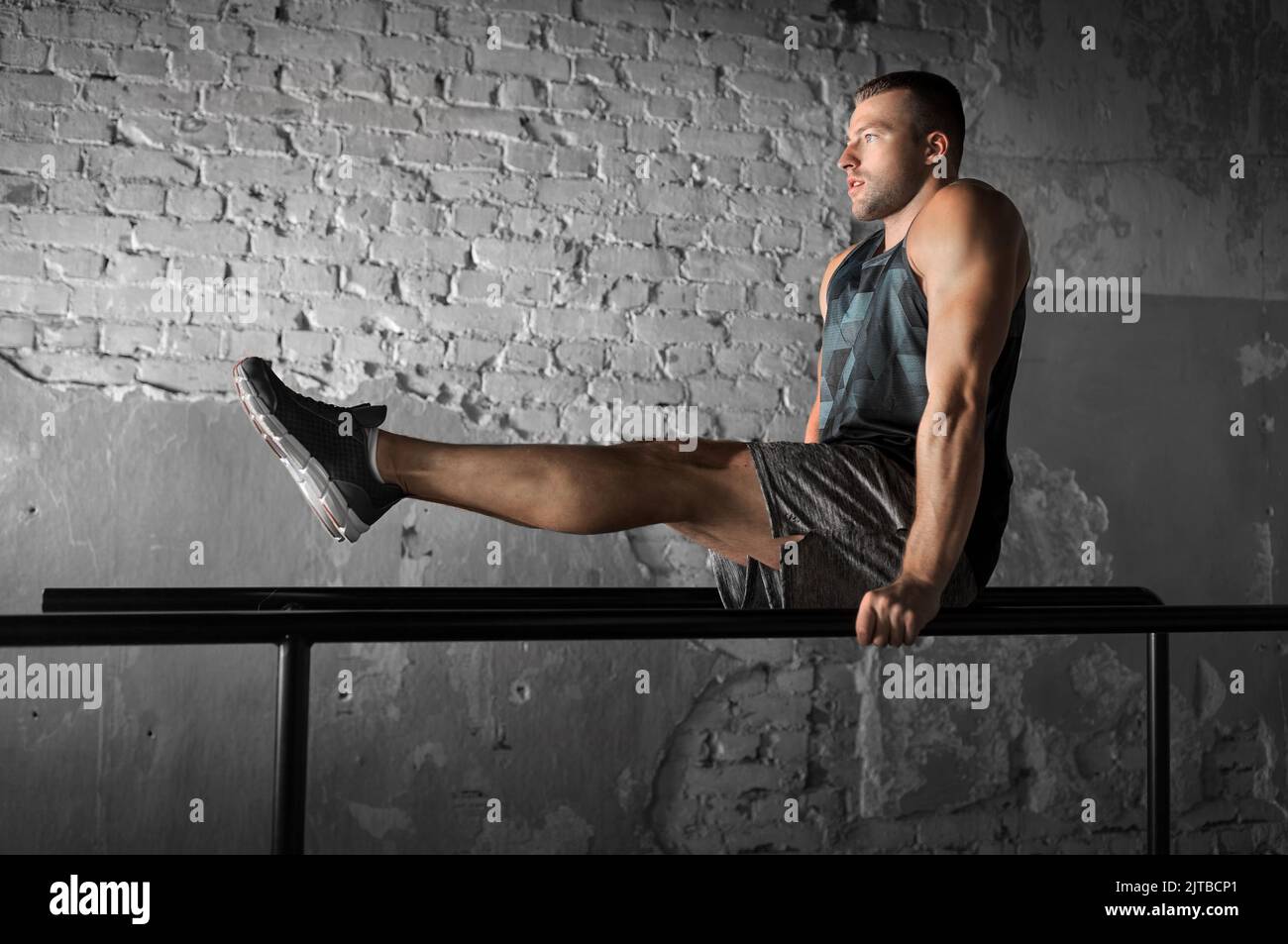 man flexing abs on parallel bars in gym Stock Photo Alamy