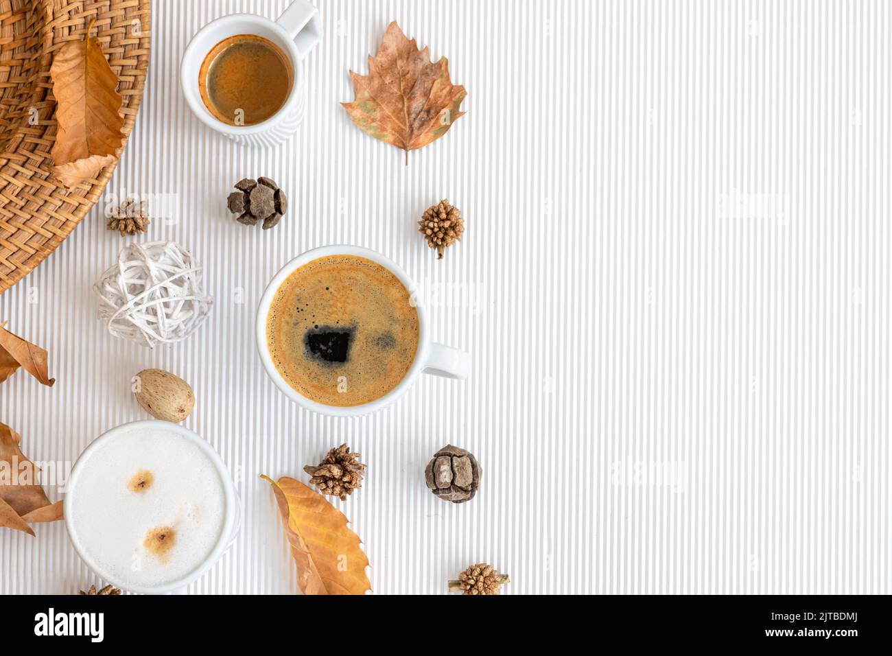 Autumn composition with cups of coffee and leaves on a white background ...
