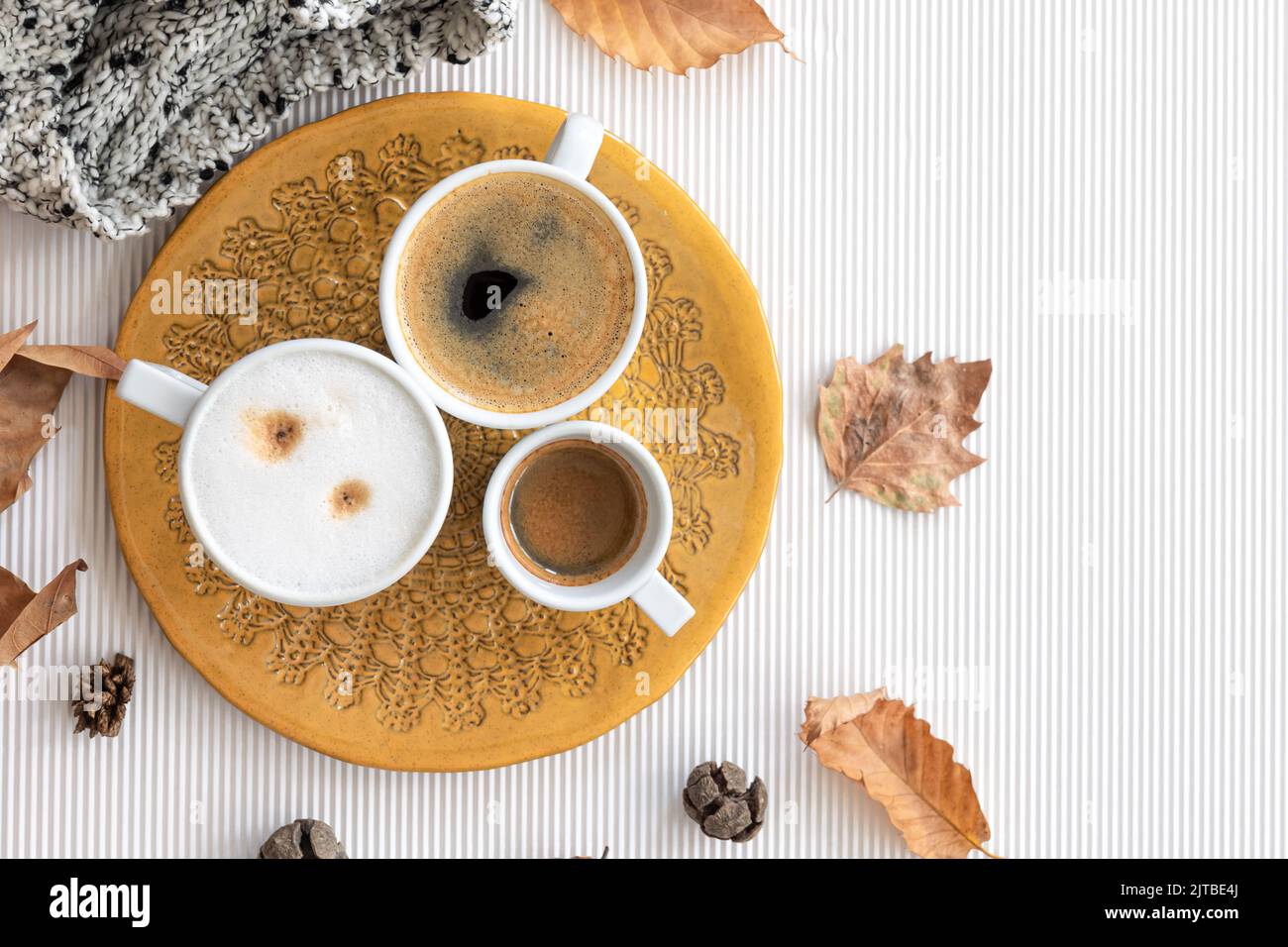 Autumn composition with cups of coffee and leaves on a white background ...