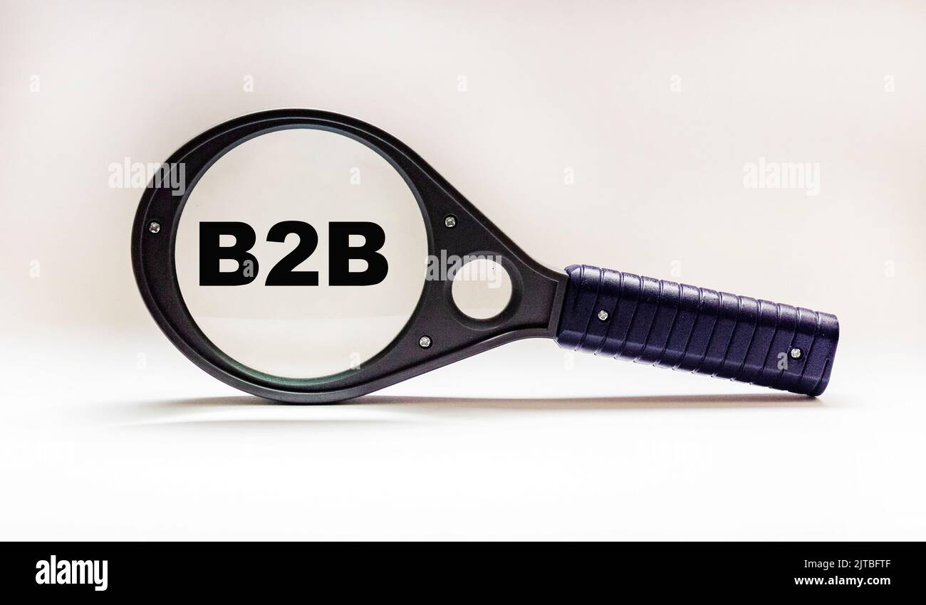 On a magnifying glass B2B icon on a white background. Space for copy. business concept Stock Photo