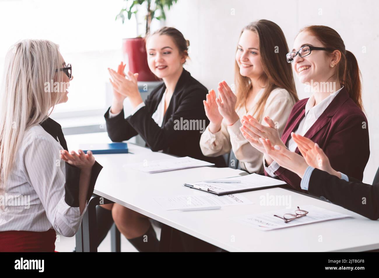 hired female business company women support clap Stock Photo