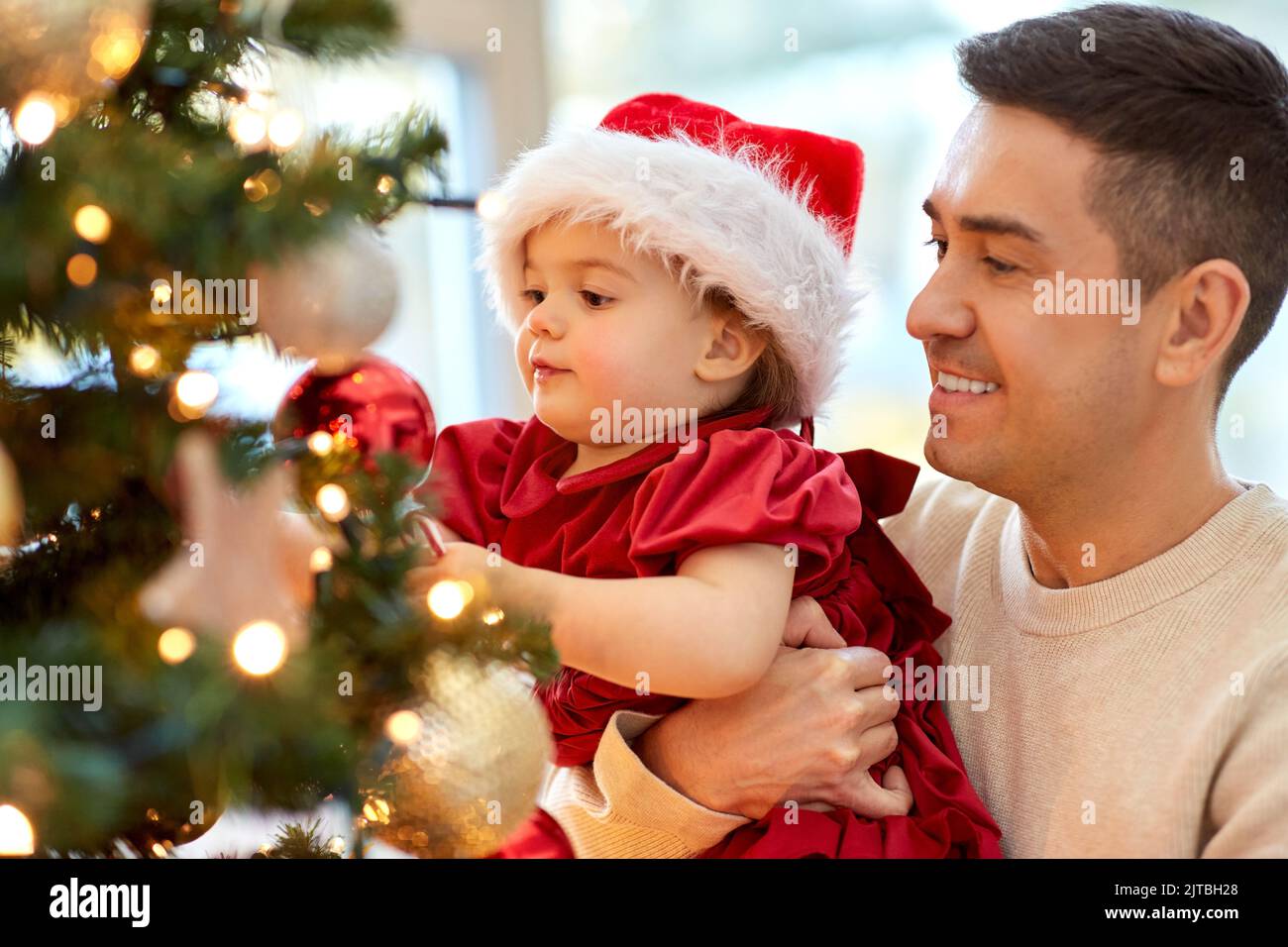 happy father and baby girl decorate christmas tree Stock Photo - Alamy