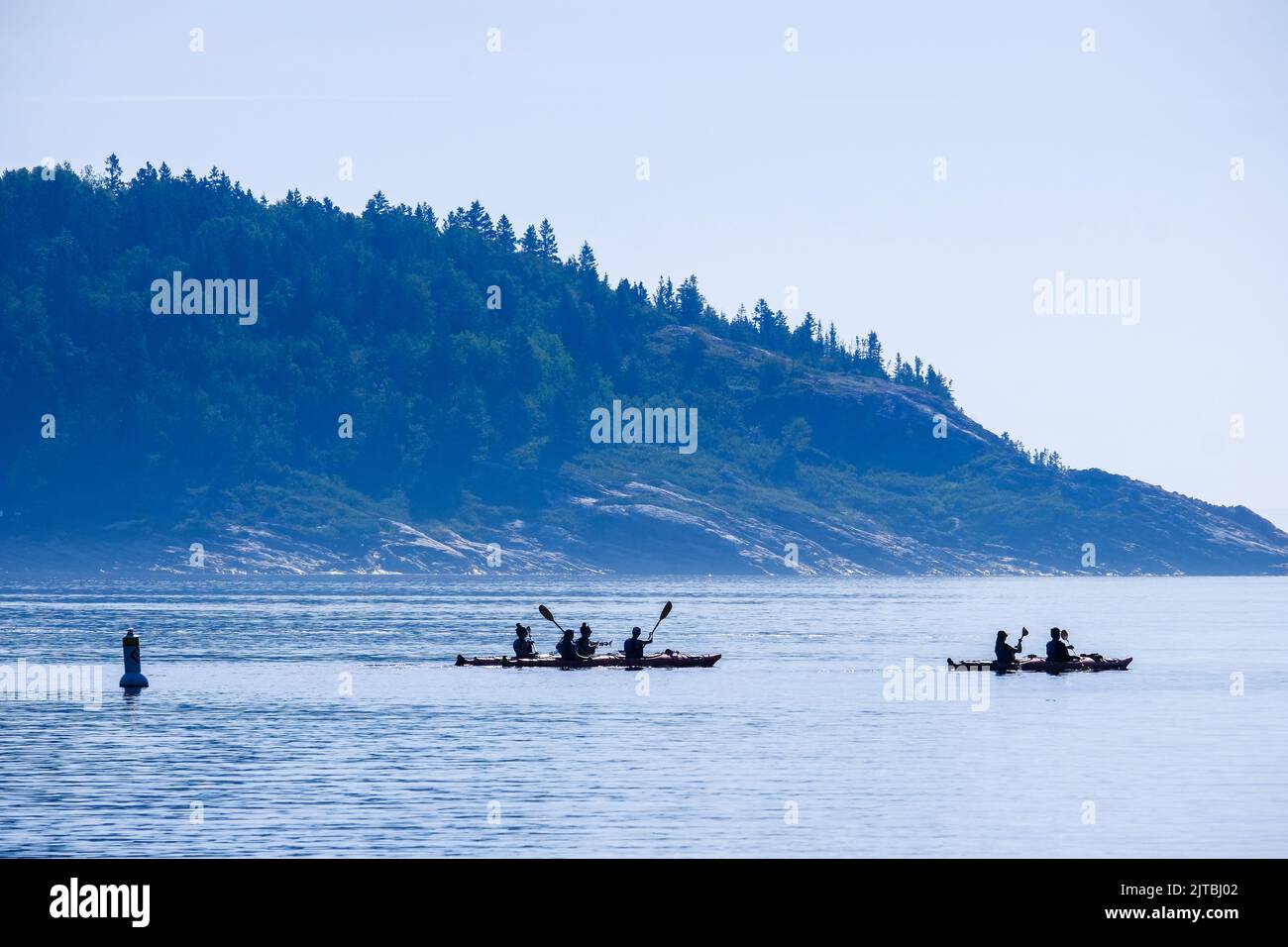 Sea kayaks heading out from harbor in Tadoussac, Quebec, Canada. Stock Photo