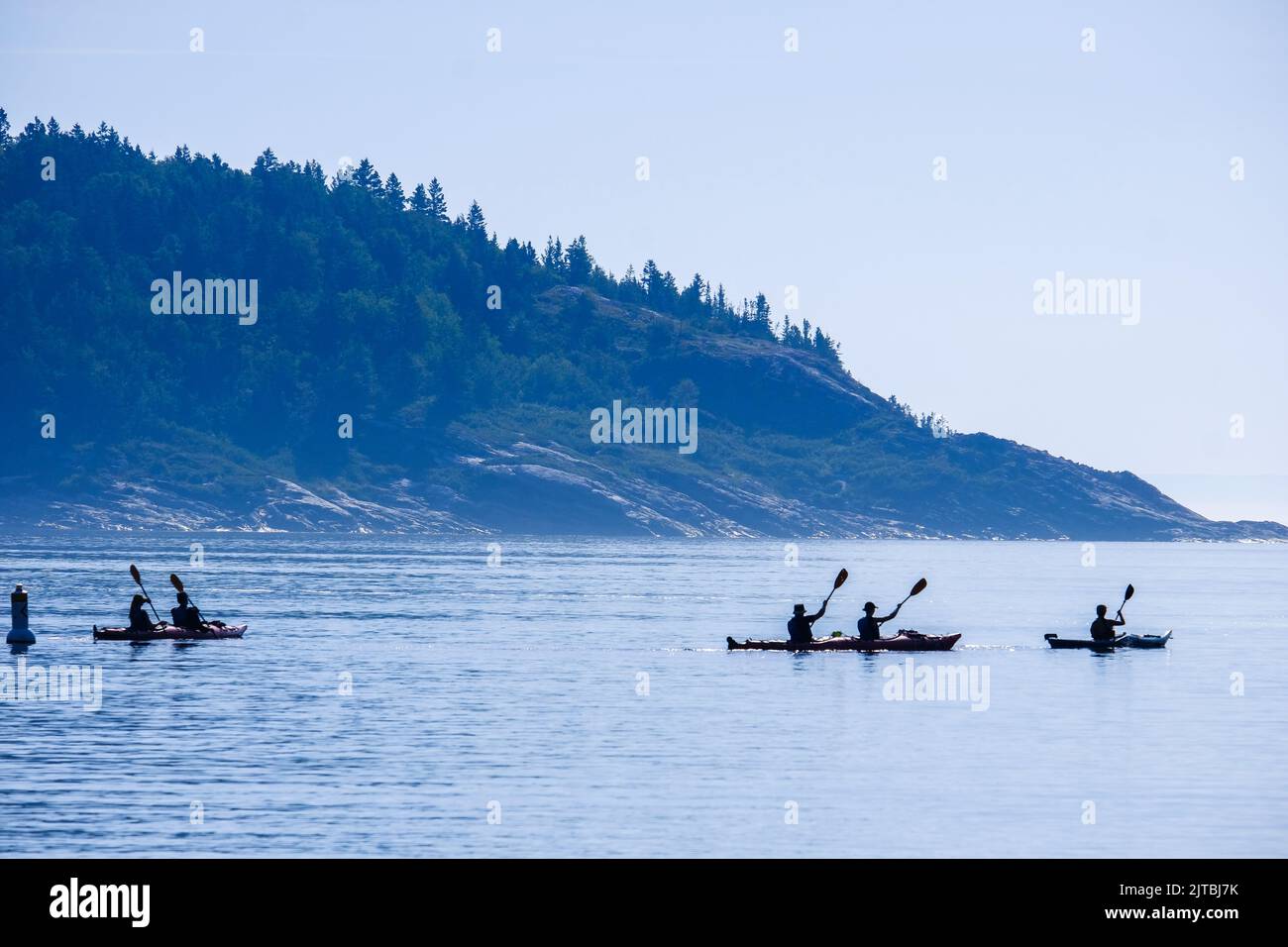 Sea kayaks heading out from harbor in Tadoussac, Quebec, Canada. Stock Photo