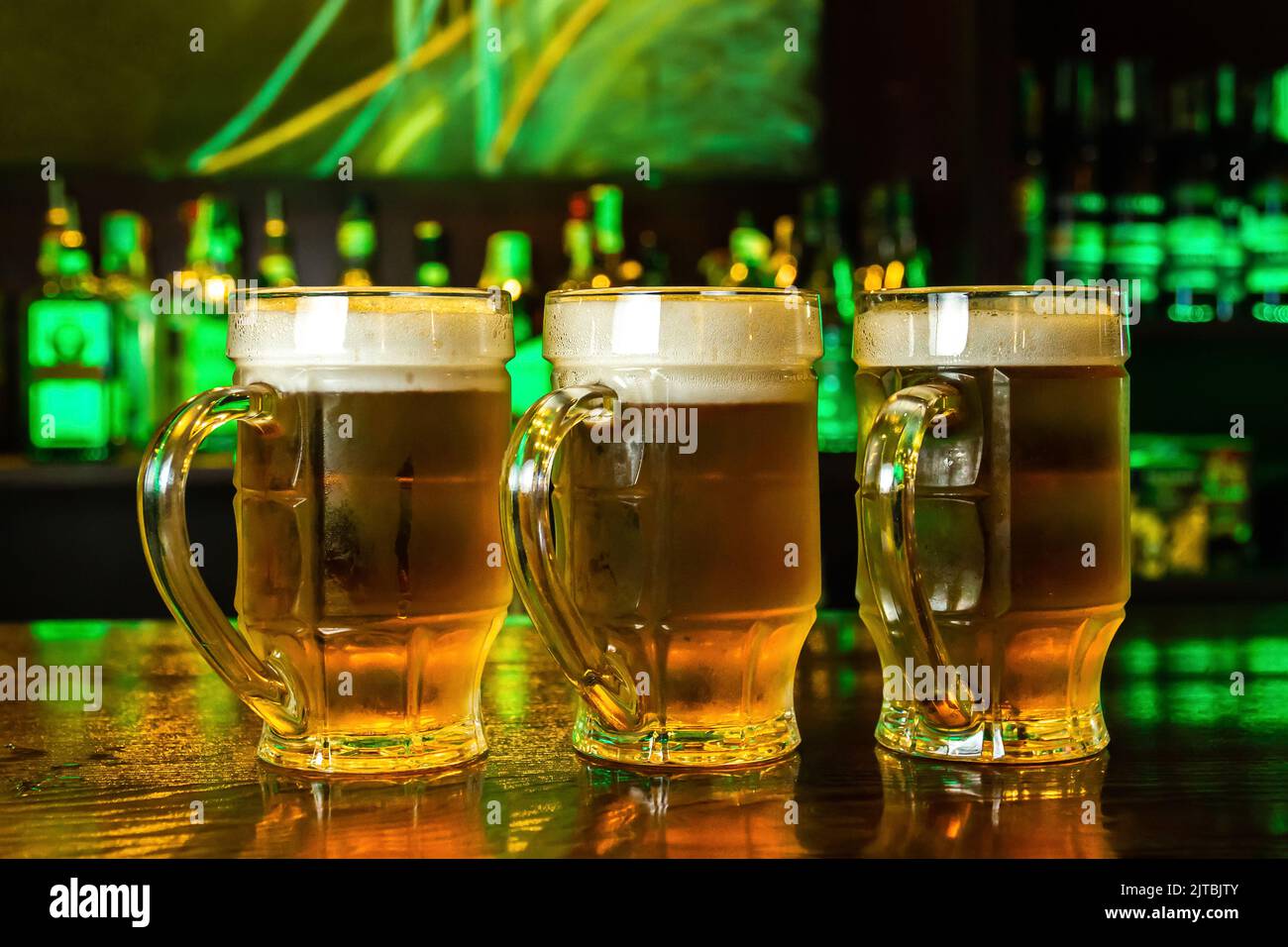 Closeup of three mugs of foamy beer on the bar Stock Photo Alamy