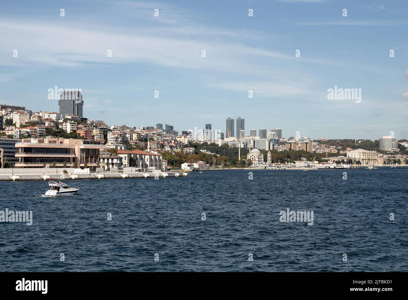 View of a yacht on Bosphorus and European side of Istanbul. It is a sunny summer day. Stock Photo