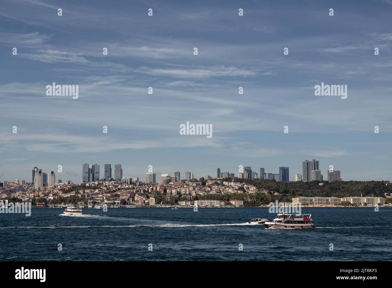 View of tour boats on Bosphorus and European side of Istanbul. It is a sunny summer day. Stock Photo