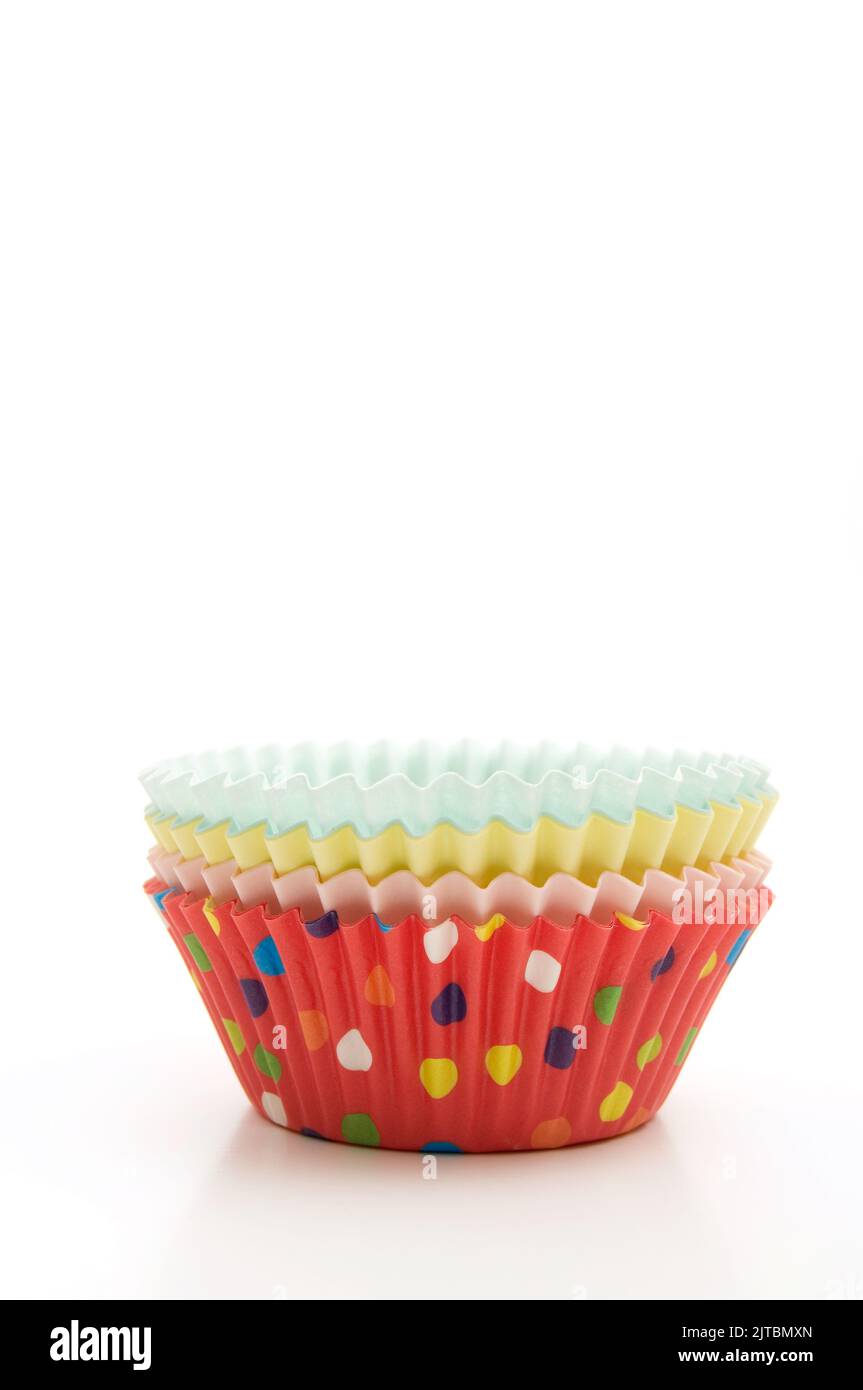 Stacked Multi-Colored Muffin Baking Cups on White Background Vertical Image Stock Photo