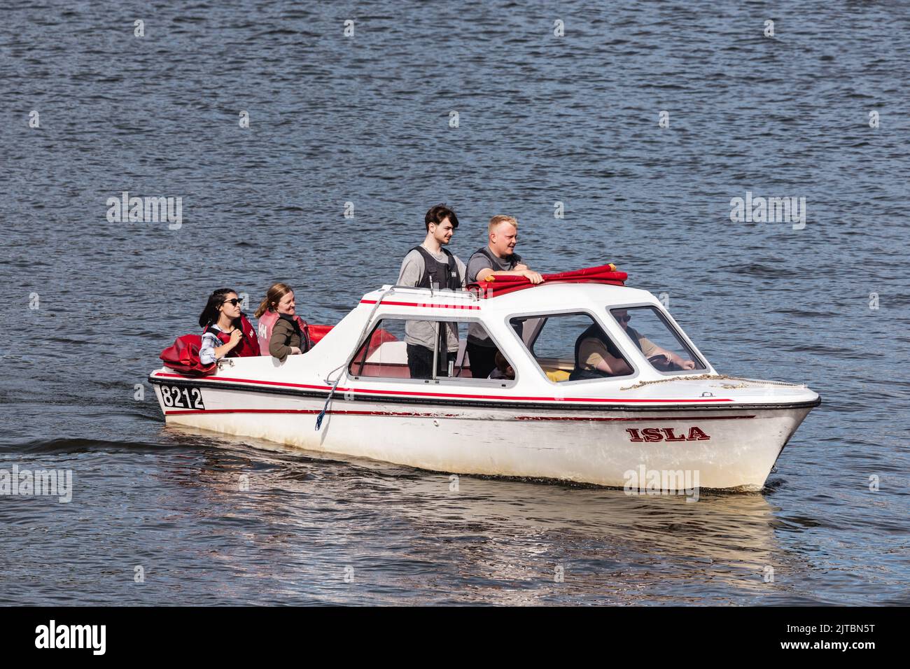 Quiet Self-Drive Electric Motor Boat Hire Explore Lake Windermere , boats can be hired for 1 or 2 hours. Dogs are welcome on board Maximum 6 people Stock Photo