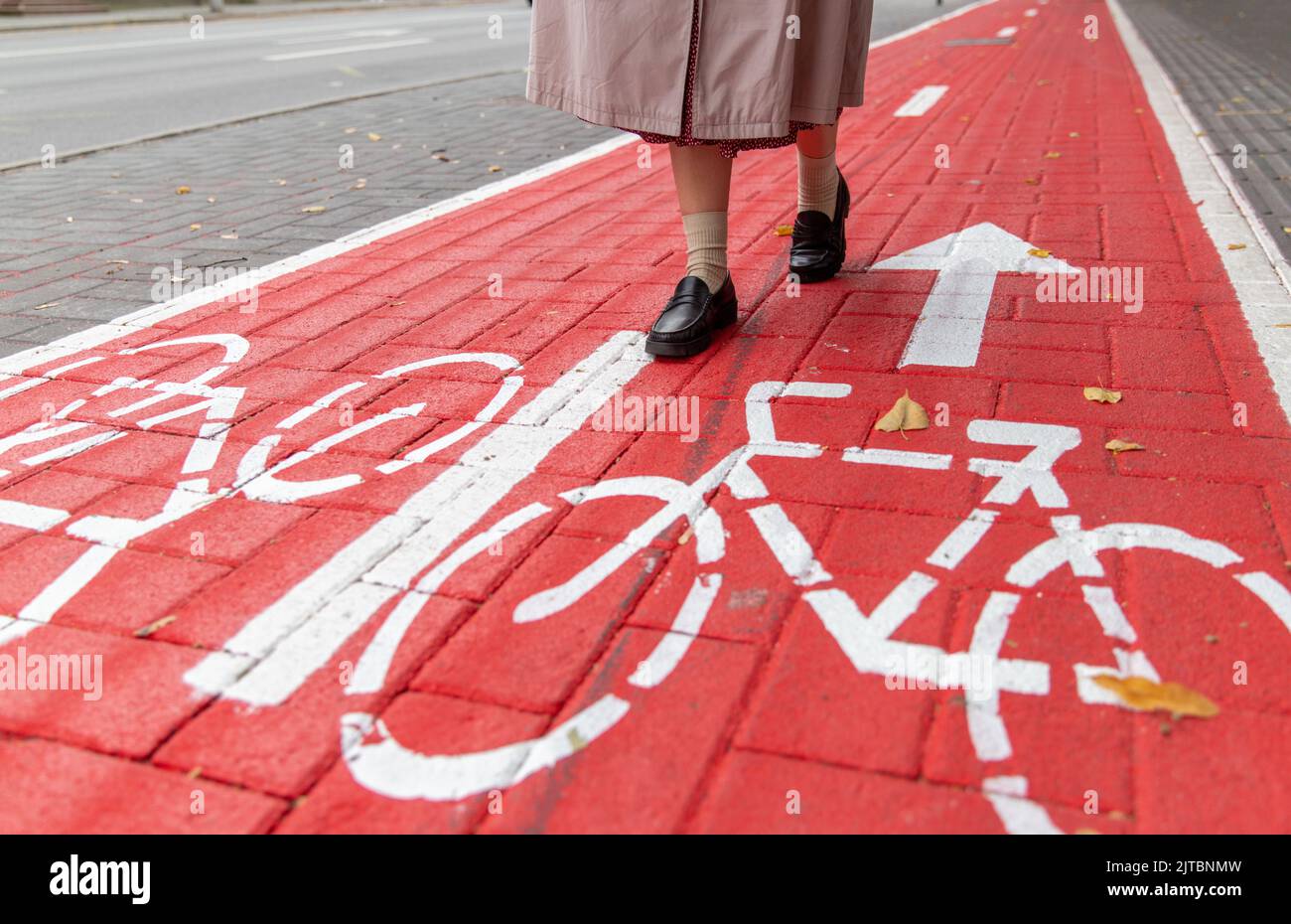 feet walking along bike lane or road for bicycles Stock Photo