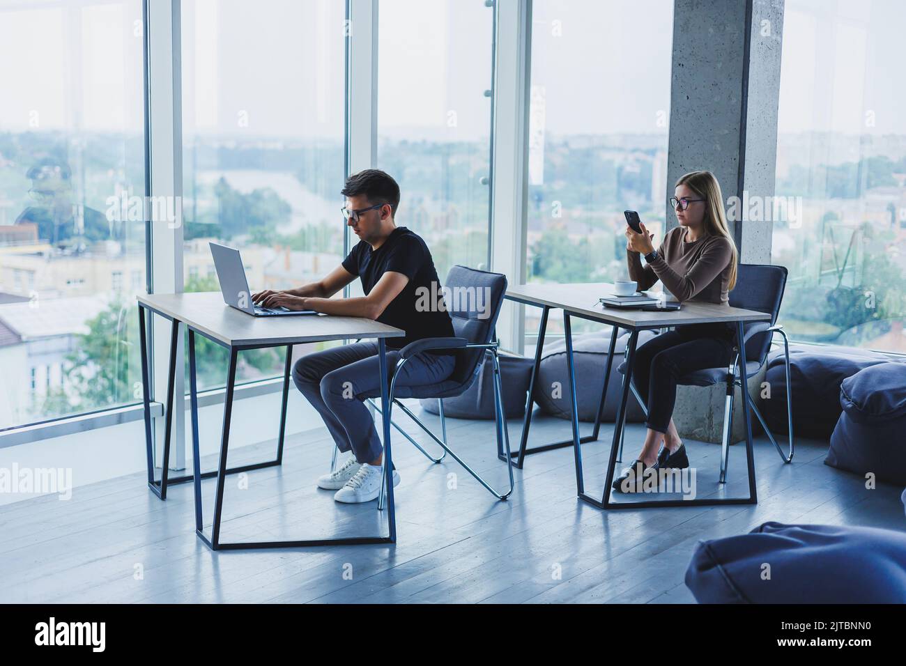 Young colleagues in the office at the desktop with a laptop. Young