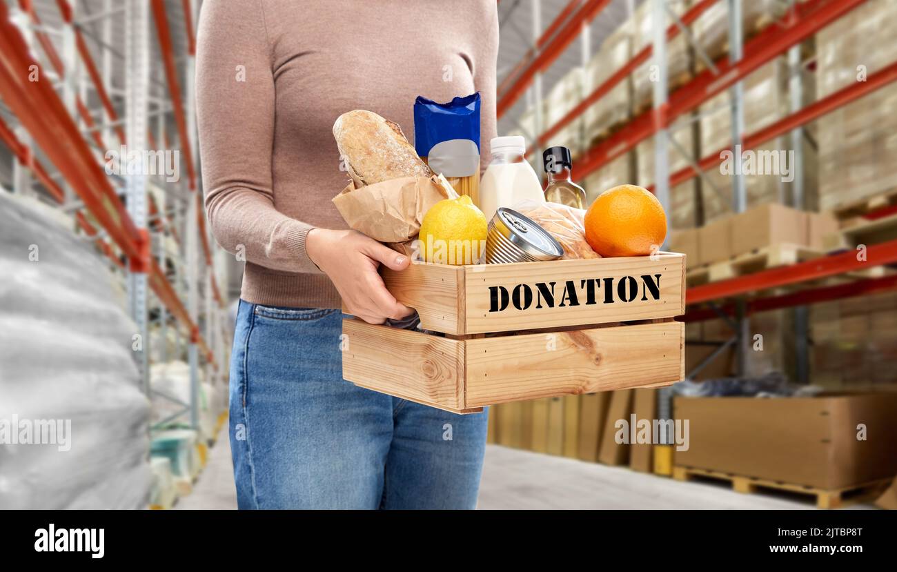 woman holds box with food donation at warehouse Stock Photo Alamy