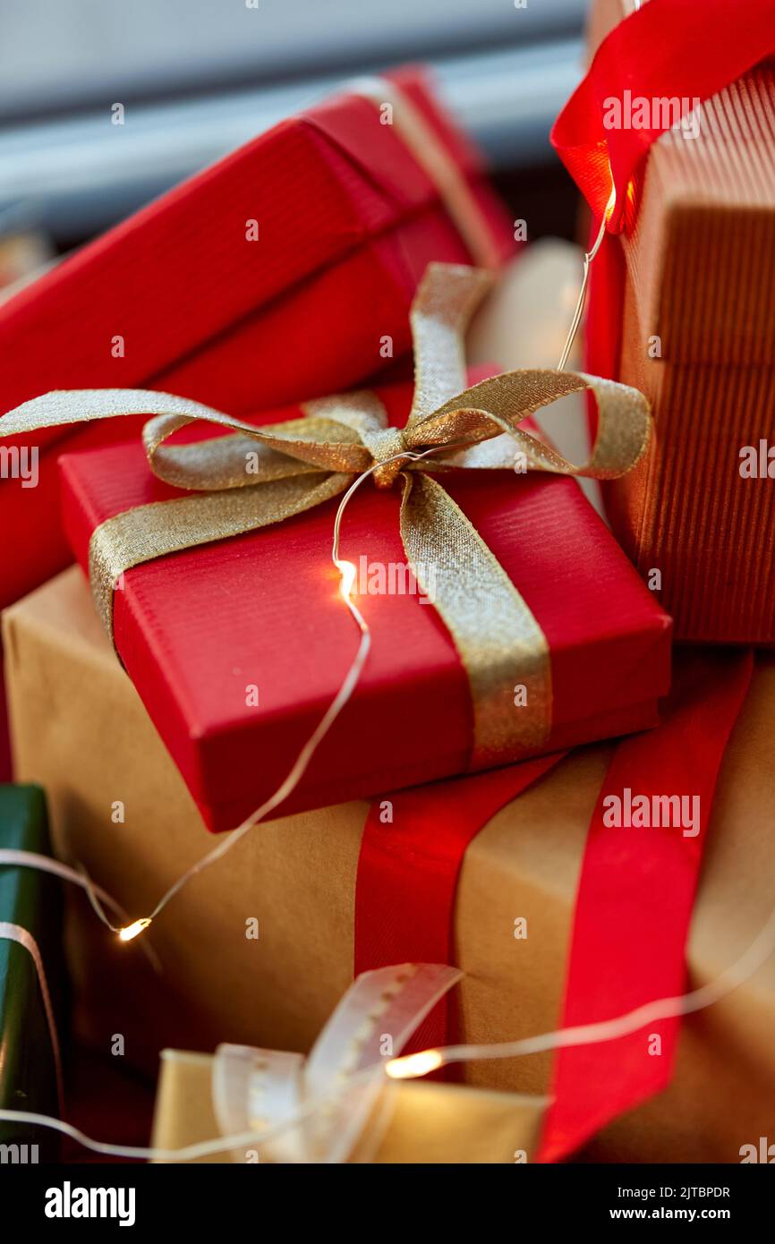 christmas gifts with garland on window sill Stock Photo