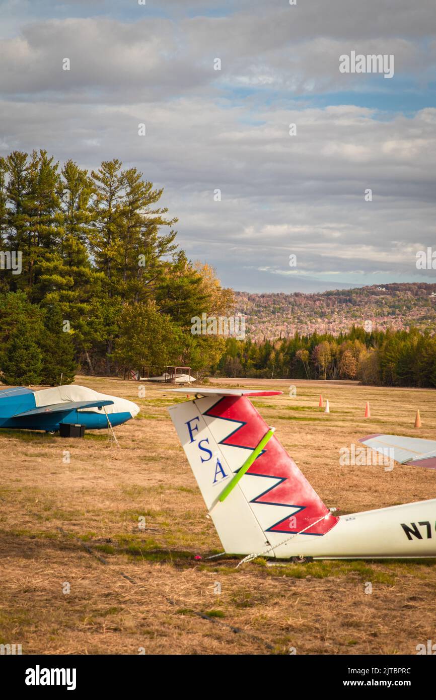 A few gliders sit in a field in New Hampshire in the fall Stock Photo