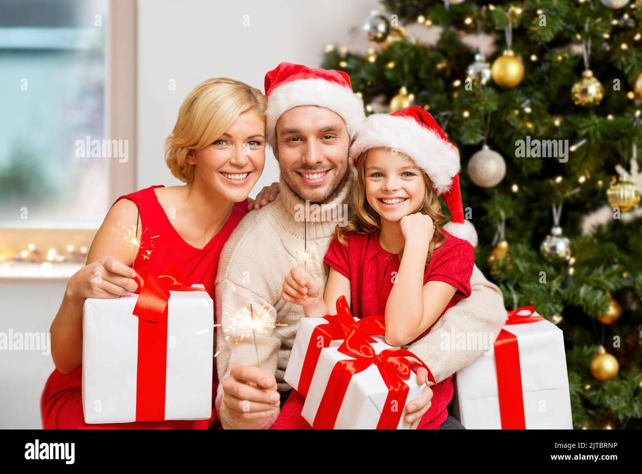 happy family with christmas gifts and sparklers Stock Photo - Alamy