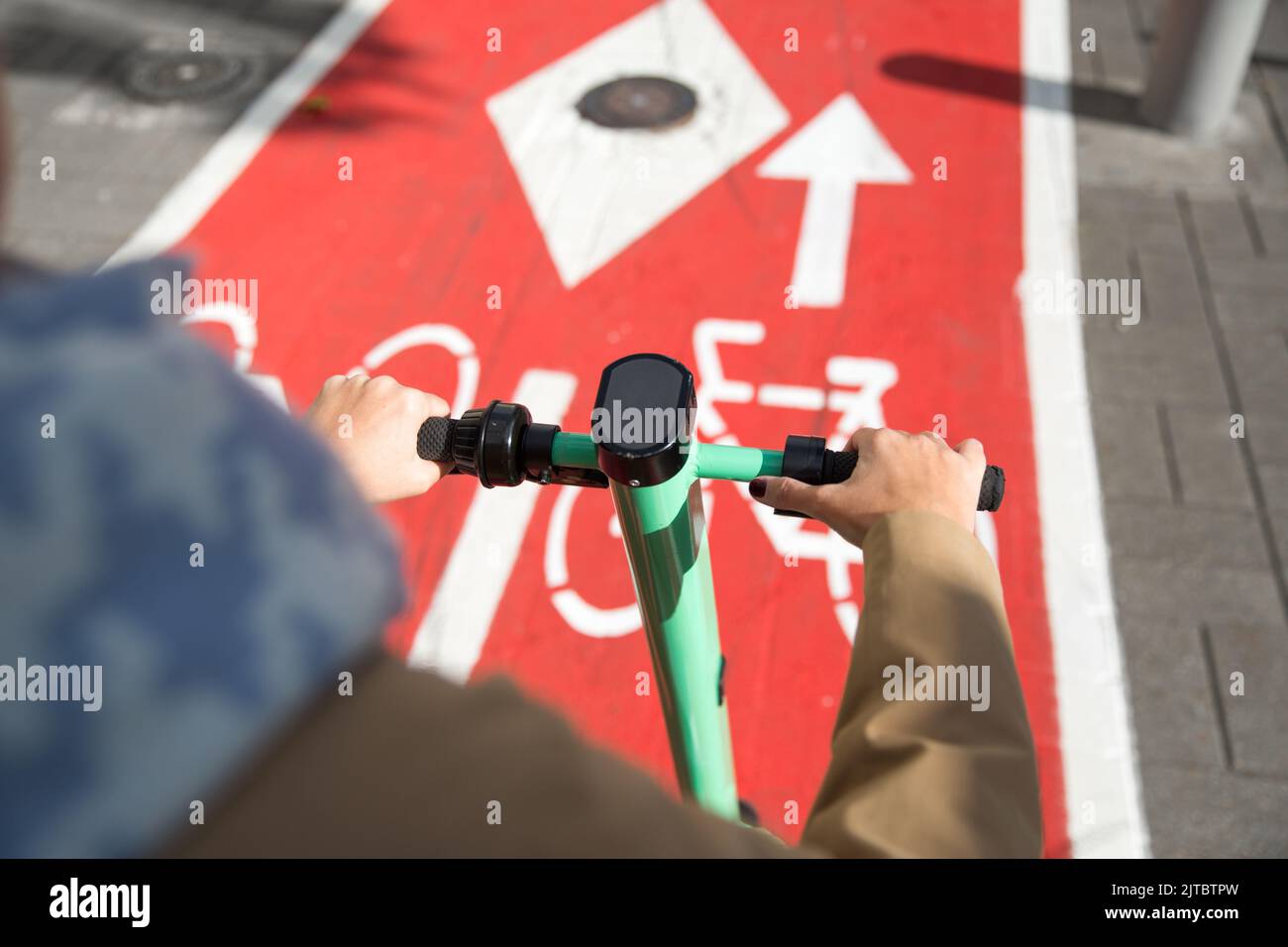 woman riding scooter along bike lane road in city Stock Photo Alamy
