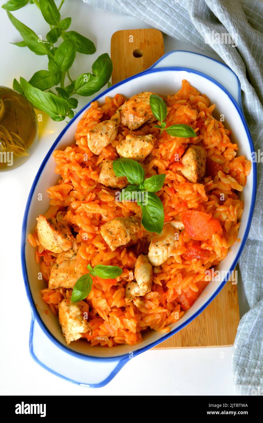 Kritharaki with tomatoes and chicken. Traditional type of Greek pasta