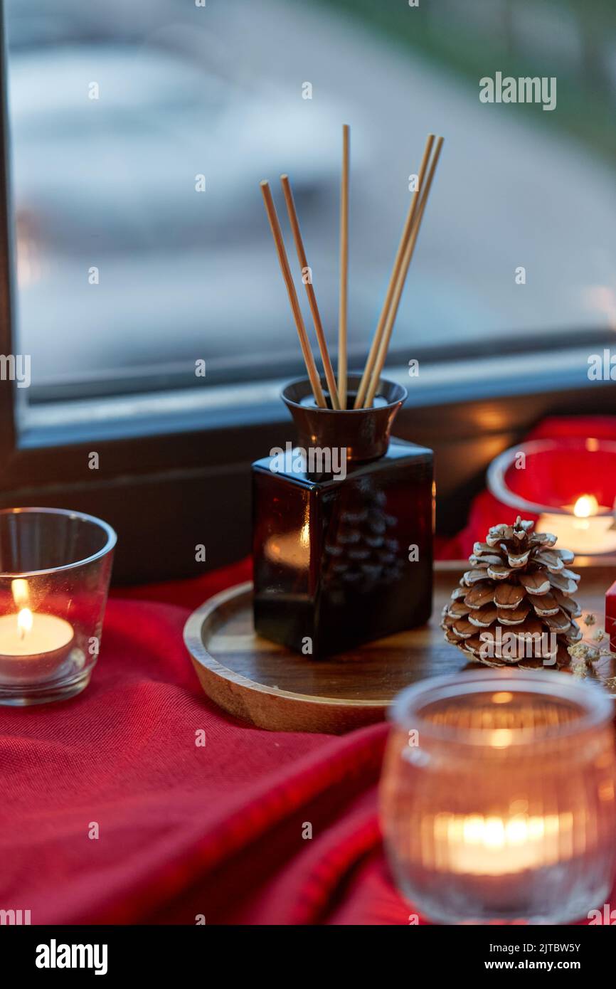 aroma reed diffuser and candles on window sill Stock Photo Alamy