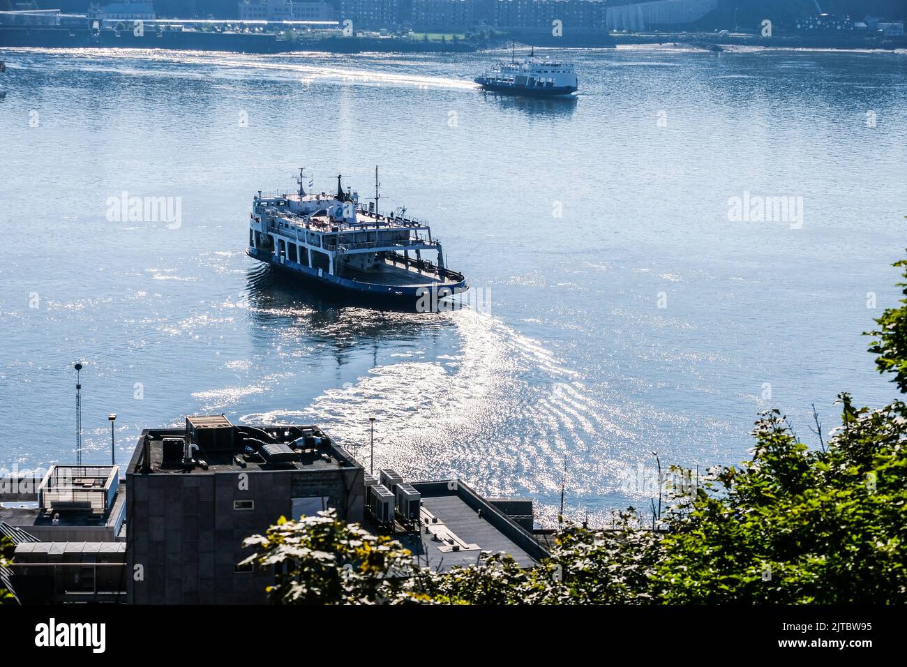 Ferries cross the St. Lawrence River between Quebec City and the city of Levis, Quebec, Canada. Stock Photo