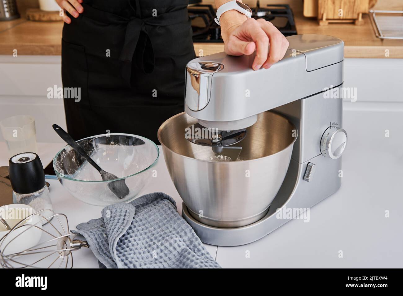 Woman cooking at preparing food, using food processor, Modern appliance for cooking Stock Photo