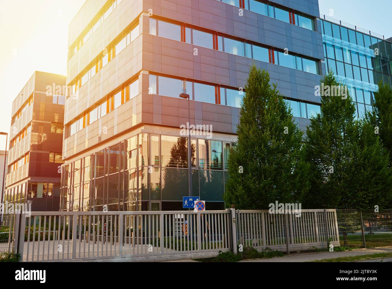 Facade of buiding with green trees, Modern office building in city for