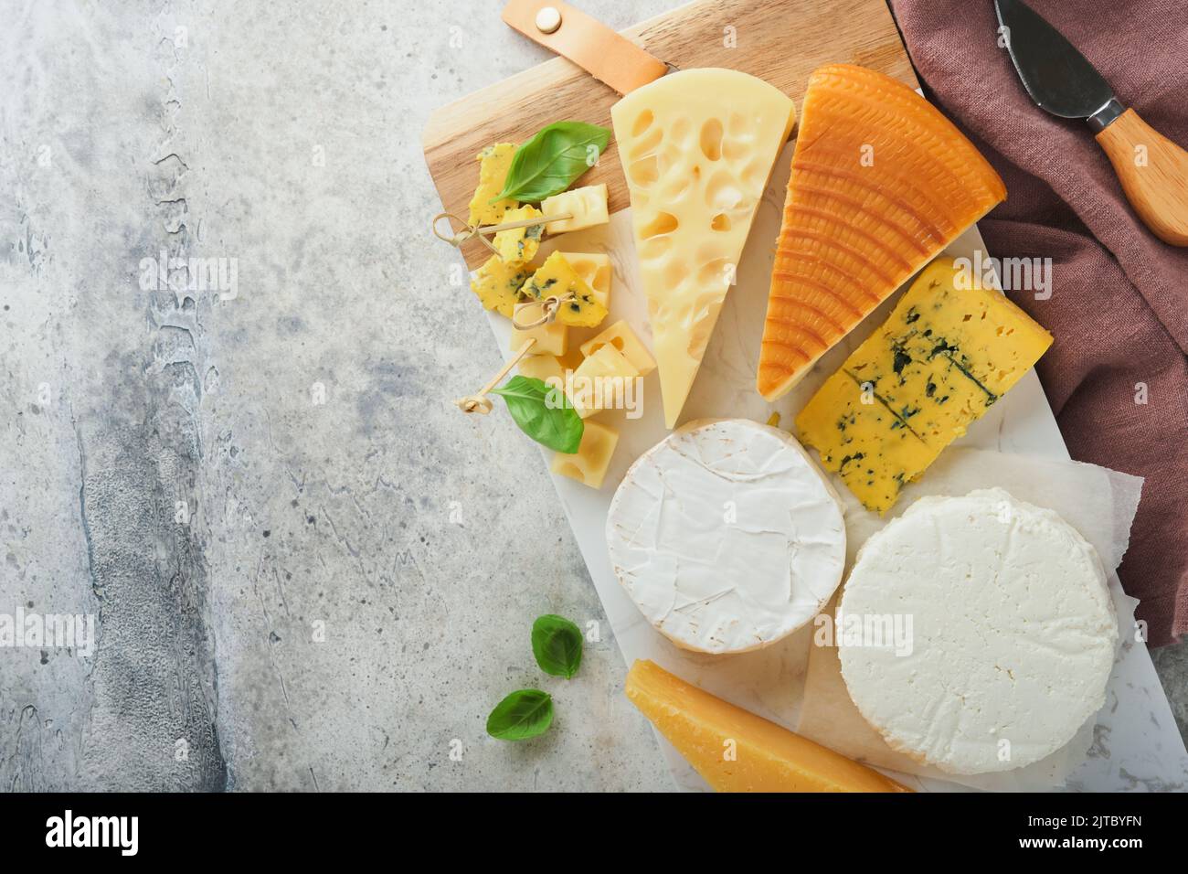 Set or assortment cheeses. Maasdam, smoked cheese, camembert, blue