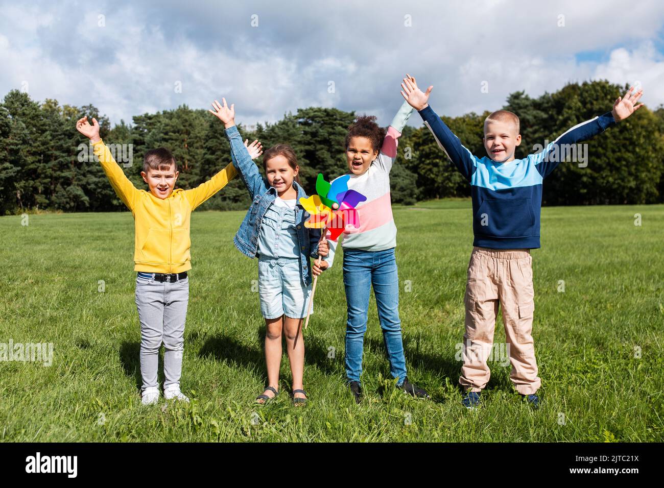 happy kids with pinwheel having fun at park Stock Photo - Alamy