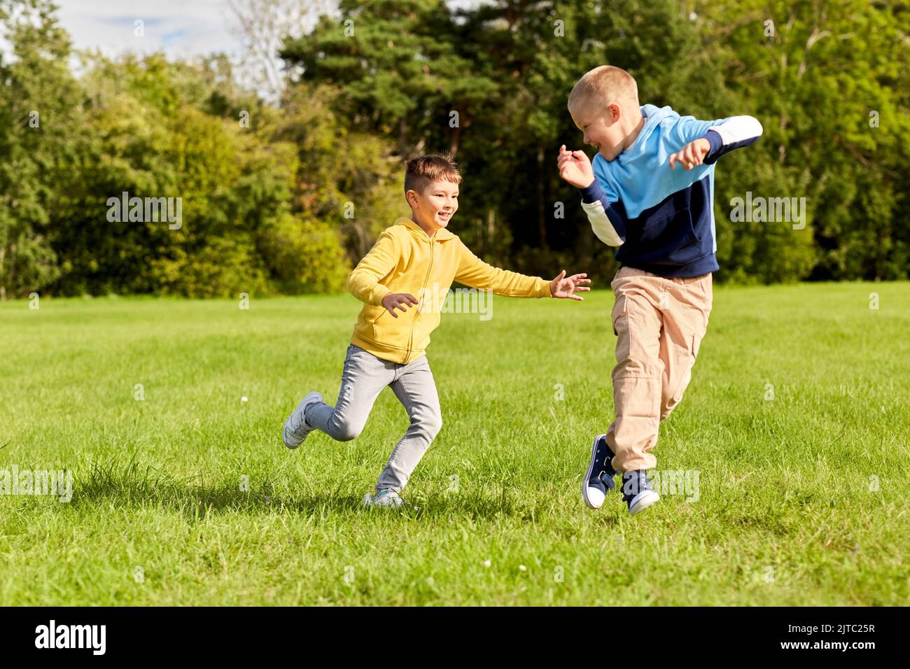 two happy boys playing tag game at park Stock Photo Alamy