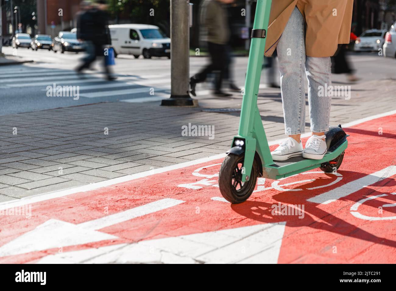 woman riding scooter along bike lane road in city Stock Photo Alamy