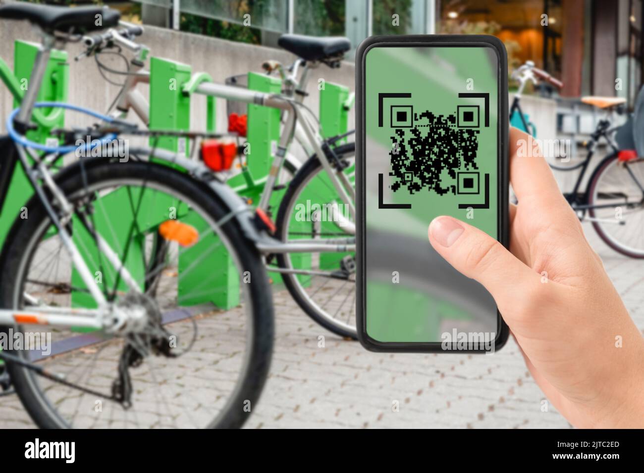 qr code on phone at electric bike charging station Stock Photo Alamy
