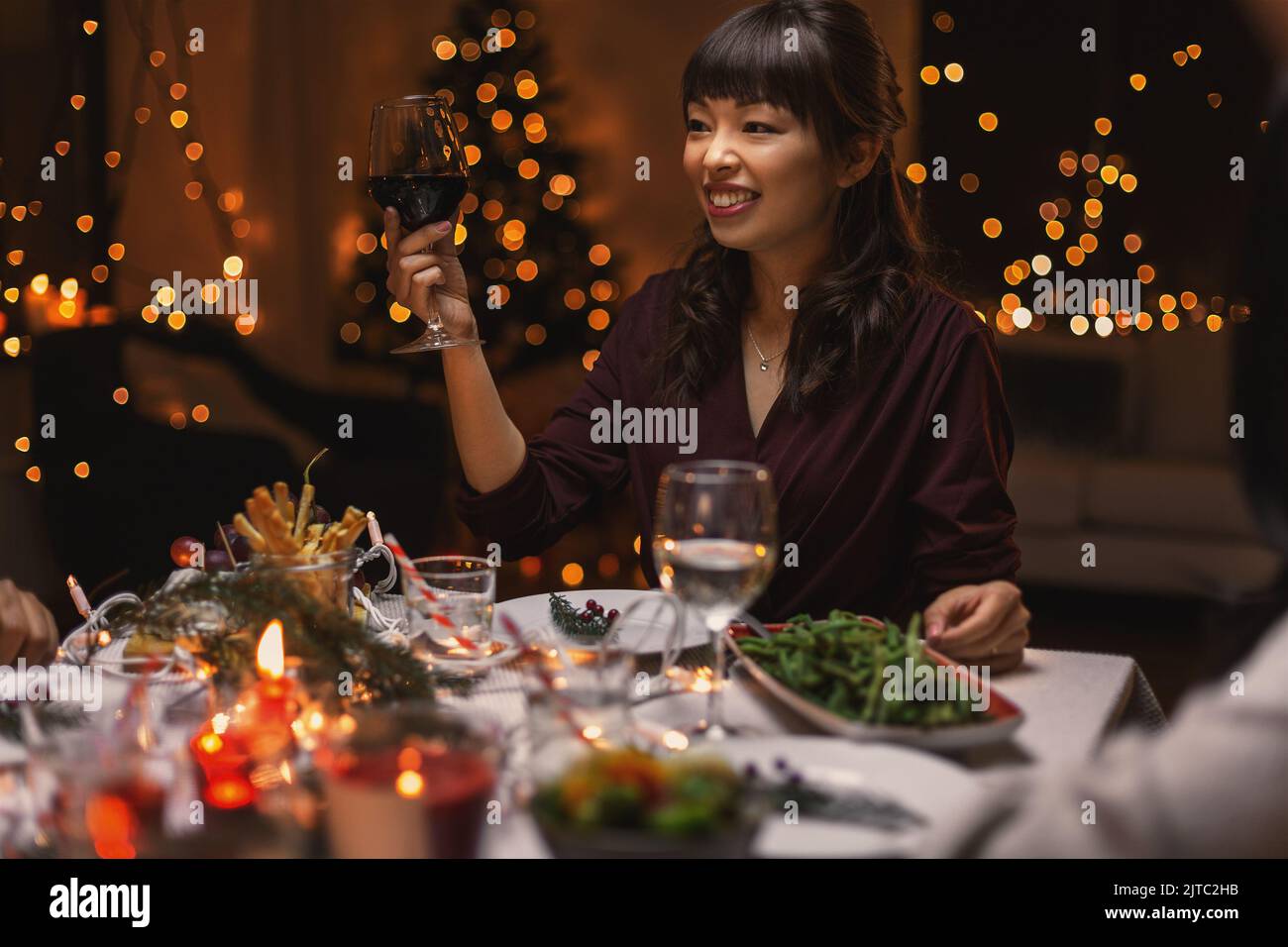 happy woman drinking red wine at christmas party Stock Photo Alamy