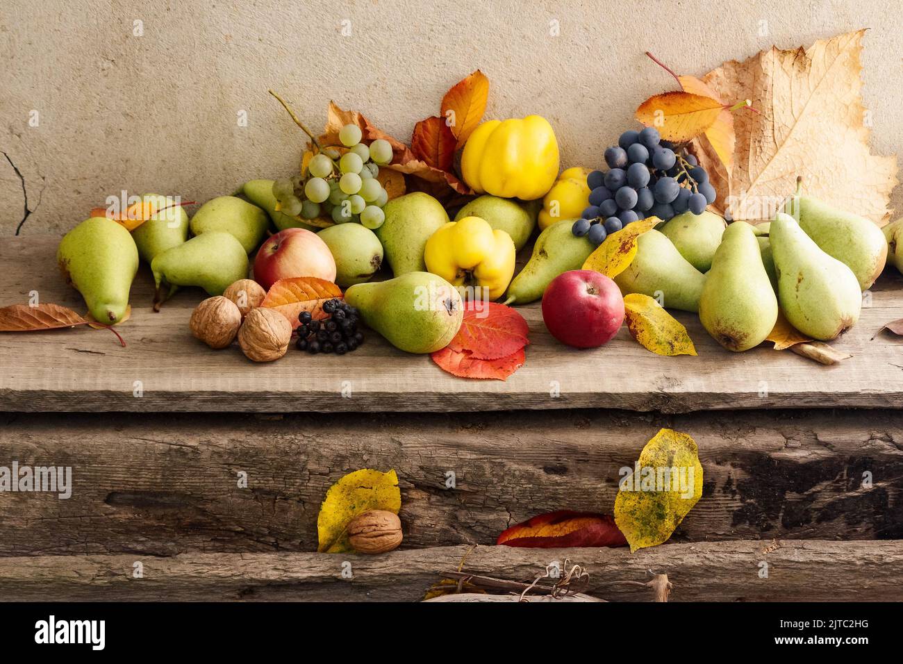 rural harvest on the wooden board. bunch of ripe fruits. organic healthy food and rustic still life composition Stock Photo